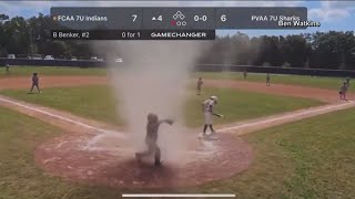 A video caught a dust devil in the middle of a little league baseball game.