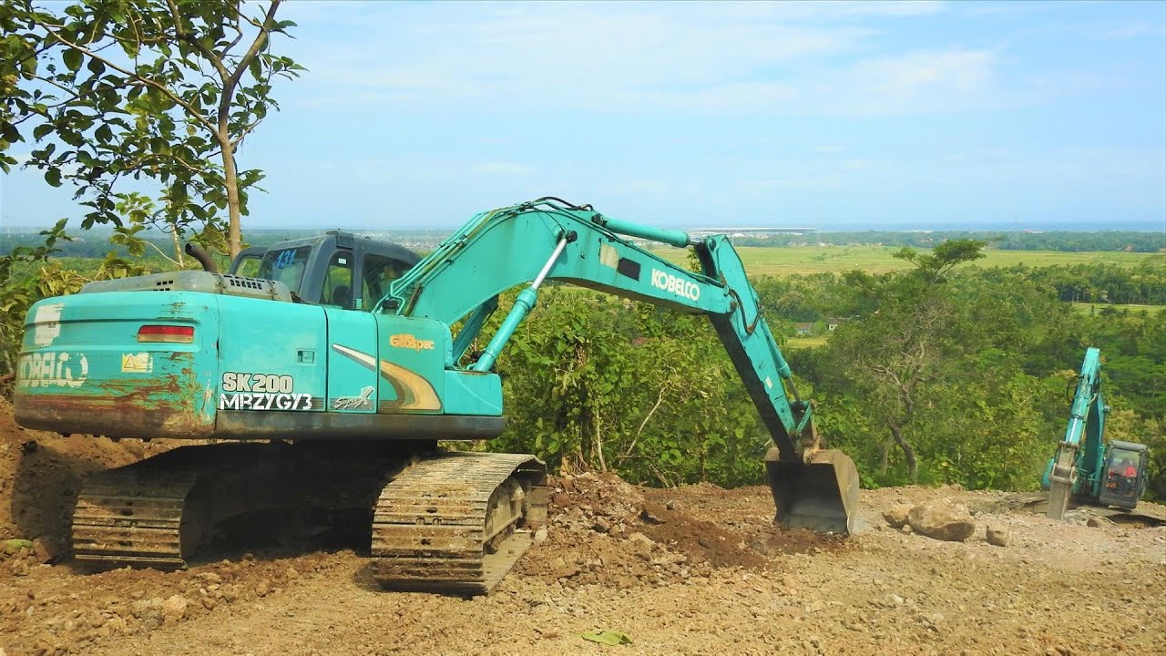 Kobelco SK200 Excavators Working With The Dirt On The Quarry - YouTube
