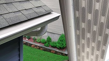 Installing gutter guards in the existing gutters on an asphalt shingle roof