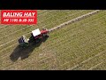 Baling hay  birds eye view  mf 1105 and jd 335 round baler