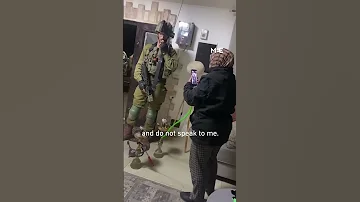 Palestinian woman scolds Israeli soldiers raiding her home as she smokes shisha