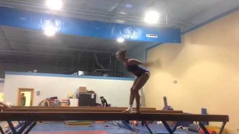 Switch leap half, back tuck on beam