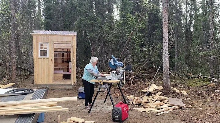 0156 Carolyn Mitchell cutting lumber at the Alaska...