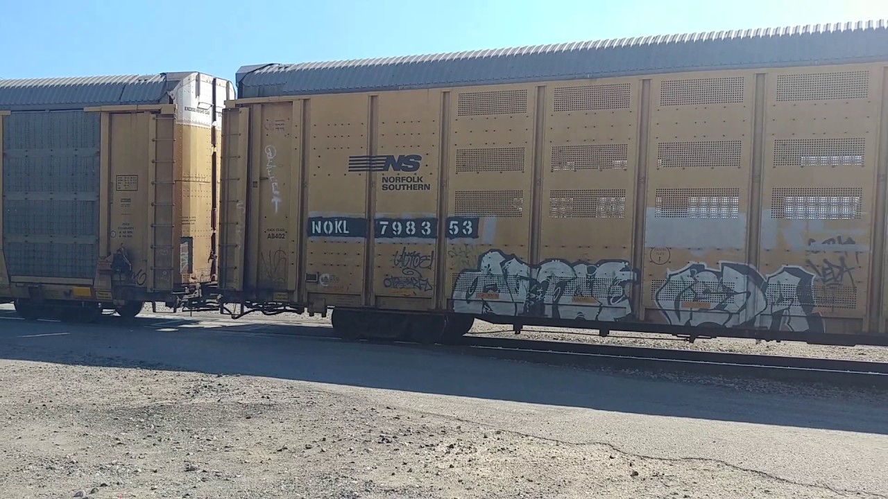 FXE 4077 leads a 69 car auto rack job northbound - YouTube