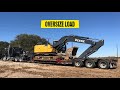 kenworth hauling heavy excavator | lowboy side loading and unloading