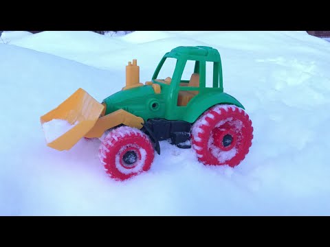 Platon in the winter playing in the yard in the tractor