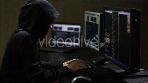 Hacker in Hood  Typing on Keyboard - Stock Footage from Videohive
