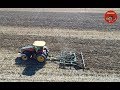 Versatile 335 Tractor pulling a Farmhand Chisel Plow