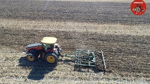 Versatile 335 Tractor pulling a Farmhand Chisel Plow