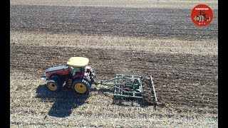 Versatile 335 Tractor pulling a Farmhand Chisel Plow