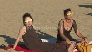 Portuguese enjoy rare solar eclipse at beach south of Lisbon