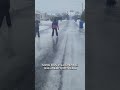 Children near Montreal skate on frozen street covered in ice