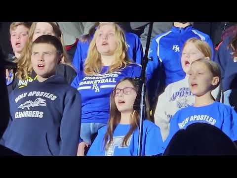 Holy Apostles School Choir sings God Bless America at hockey game