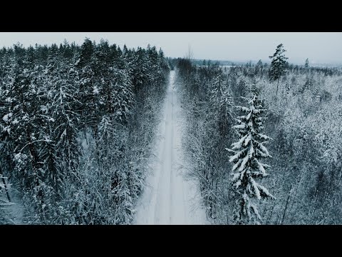 Drone flying forward over snowy winter road, 4K stock video