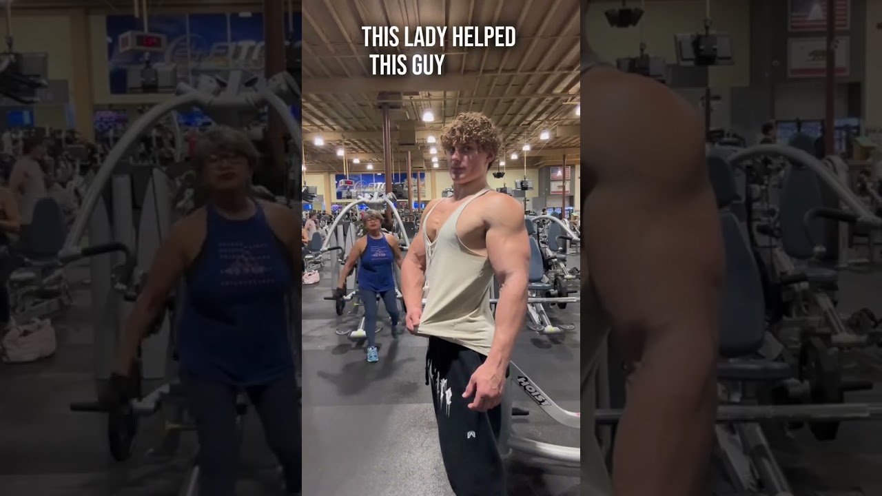Lady Helps Guy Pose In Gym