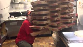 61 pizza boxes held in hand