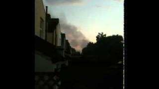 Europe - UK - Croydon, London - 20110808 - Resident watches smoke while expressing her view.
