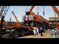 Loading of Kato Nk 1200 on trailer with cranes part 2