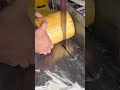 making a neat small circle pattern on a grey concrete wall surface using an industrial iron round