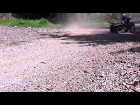 My 10 yr old son doin donuts on his SUZUKI lt250 quadrunner