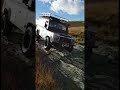 Defender decending rocky section on welsh green lane