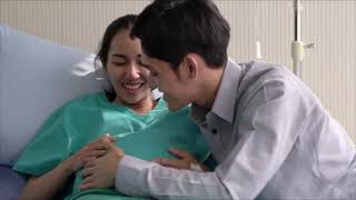Asian Man Listening to A Pregnant Woman's Belly