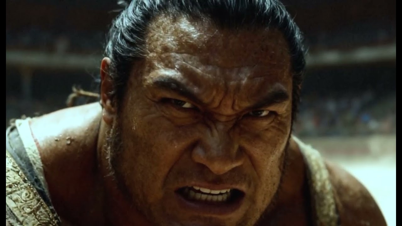 A bear is doing sumo wrestling with a man.😆💪