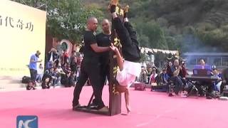 Shaolin monk stands on one finger