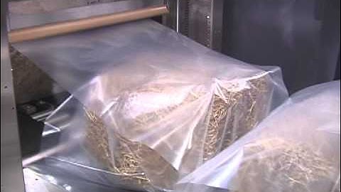 Inline Shrink Wrapper Running Hay Bales