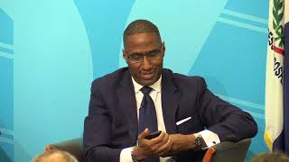 Zack Reed receives a phone call during the mayoral debate
