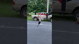 Boy attempts to dunk basketball on hoop then falls and lands on back