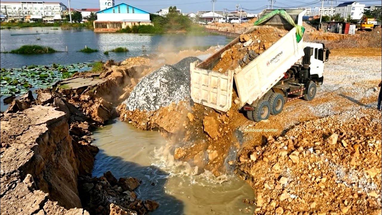 New update dump truck wheel 10 unloading stone landfill flooded & bulldozer DH17 working push soil.