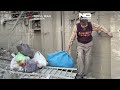 Workers clear rubble after US-Israeli strikes damage buildings in Tehran