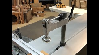 Sliding table saw cam clamps