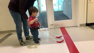 A one year old toddler boy with light perception only tries a wearable cane