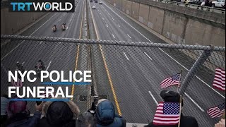 Thousands gather to honour slain officer at Manhattan funeral