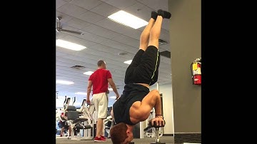 Final set of handstand push-ups on Dumbbells