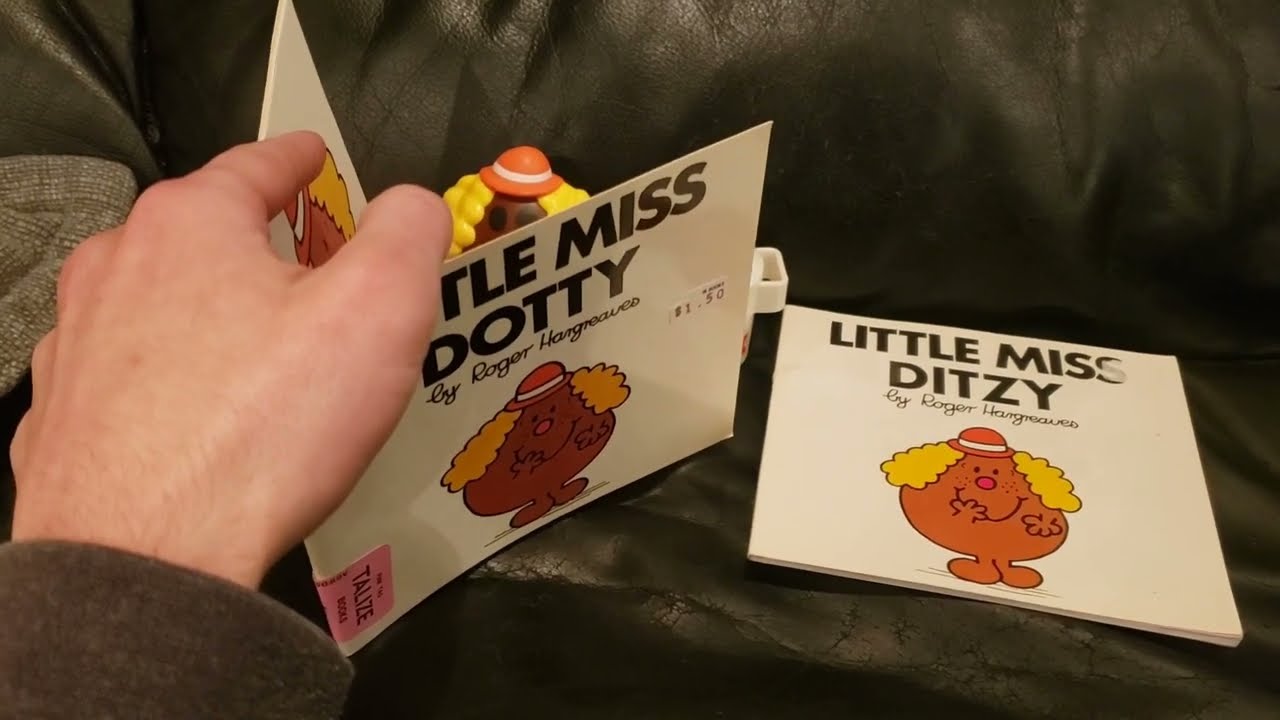 Little Miss Dotty Reads Her Own Books While Drinking Her Milk