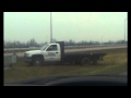 Driver goes offroading in a flat bed truck