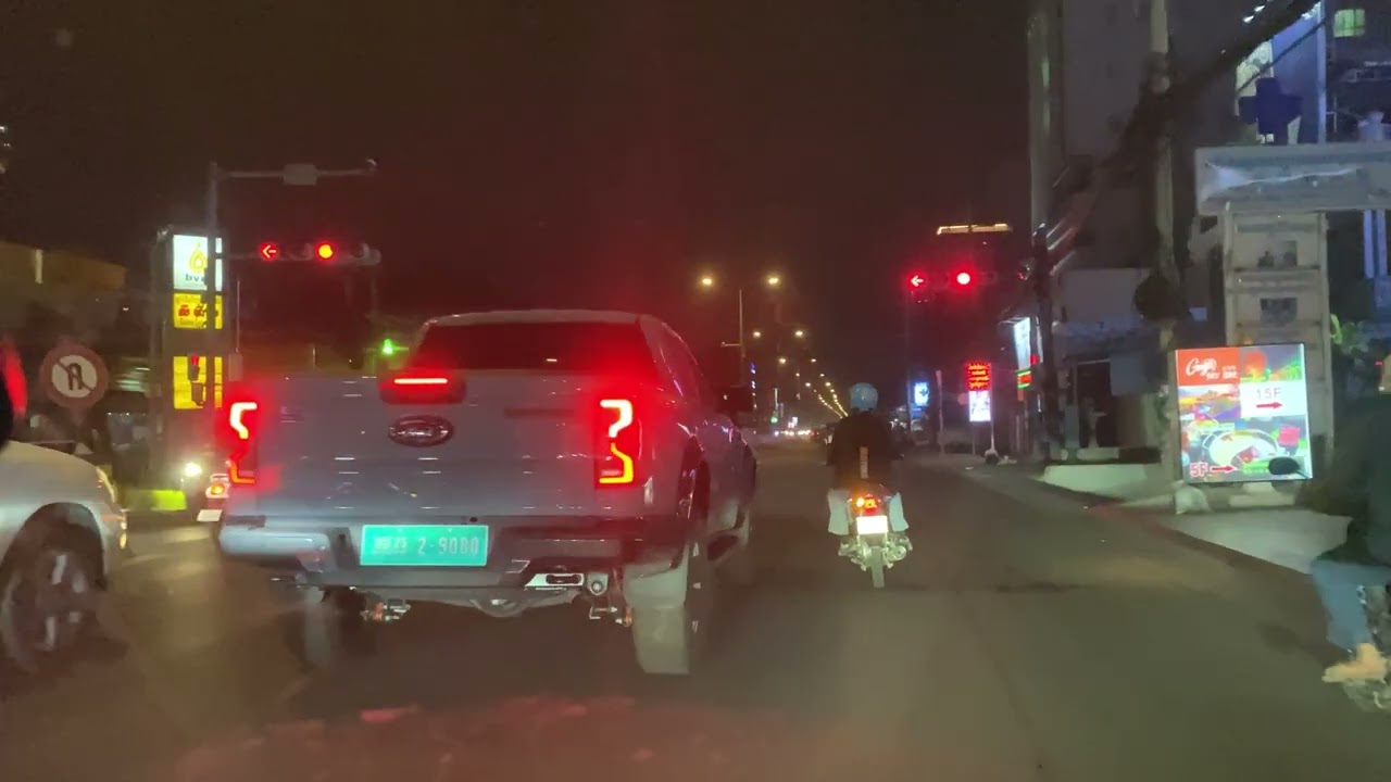 A view of the street under the Paum Makara Bridge at night.