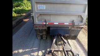 Gravel trains spread dumping county road