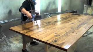 reclaimed wood top Craftsmen working with discarded oak from an old pier and giving it new life as a center island.