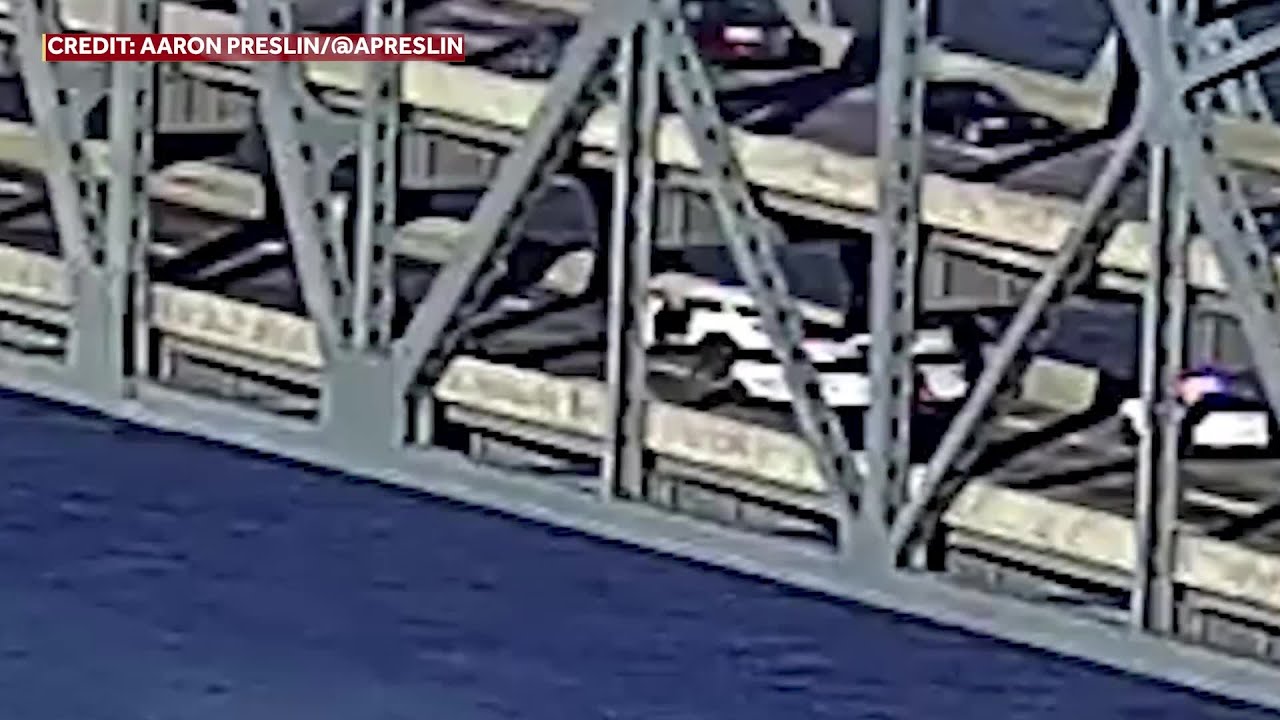 RAW VIDEO: Man climbs underneath bridge to flee police after chase ...
