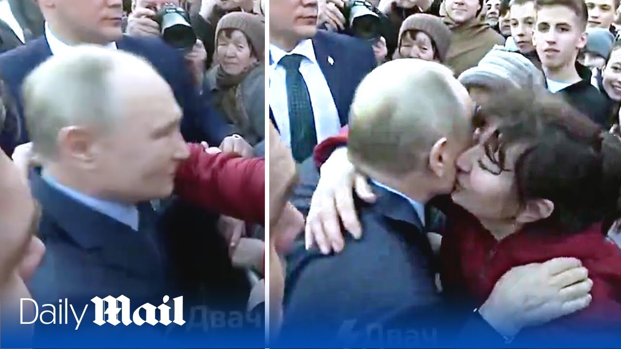 Putin kisses and hugs women during public visit