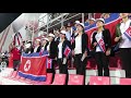 Supporters of North Korea are singing the national anthem before the game against Saudi Arabia