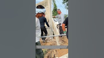 Workers Installing a Concrete Panel Fence for a Livestock Farm
