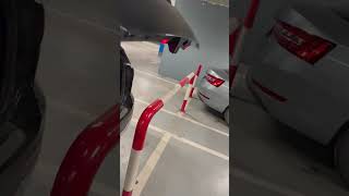 Car trunk closes with perfect clearance beside barrier in Belgrade, Serbia