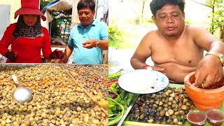 A man eating very tasty Sun dried clams with fresh vegetables eating food