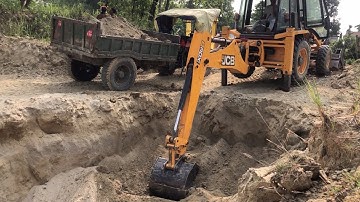 Two Tractor Vs Backhoe Loader / JCB Machine Loading Soil In Tractor