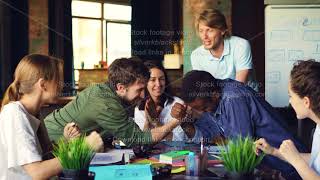Young people are having fun in office competing in arm wrestling, two guys are taking part in screenshot 1
